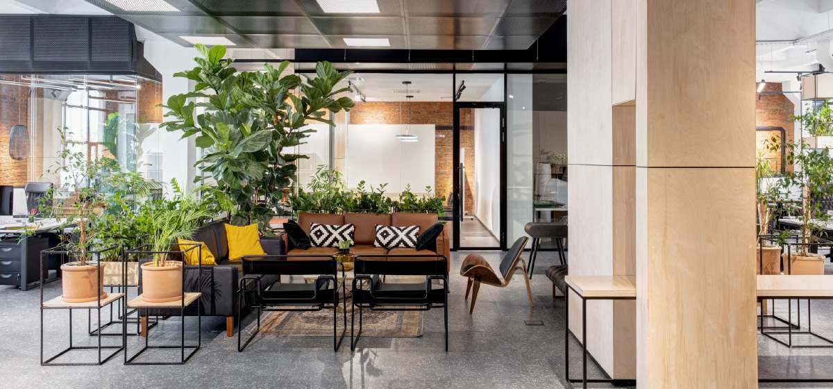 Modern open space office interior with furniture and plants