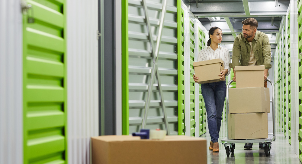 Couple Moving Boxes in Storage Unit