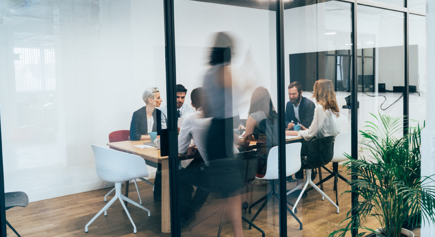 Office workers meet in a modern conference room.