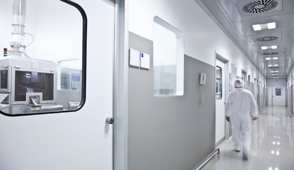 Employee walking down hallway of life sciences lab