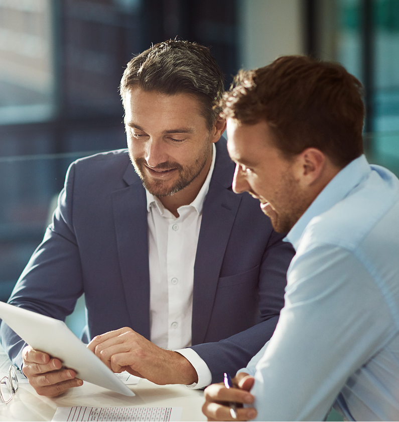 Two colleagues reviewing a tablet together