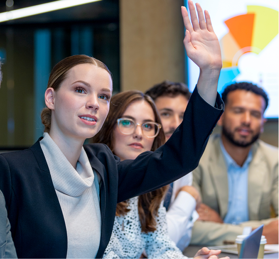 Woman raising hand during a business meeting with colleagues