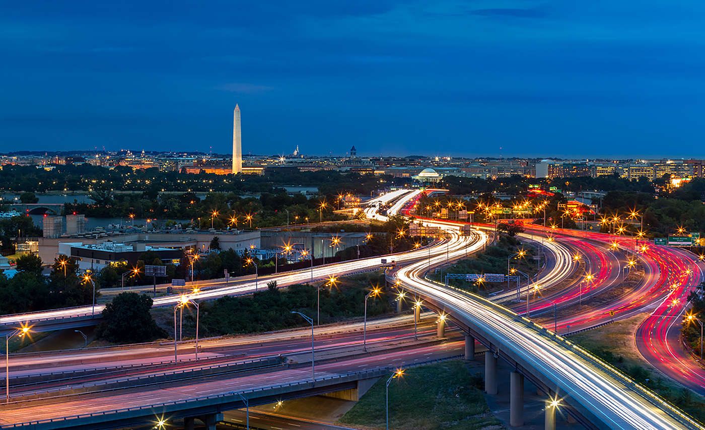 Busy highway system with the Washington monument looming in the background